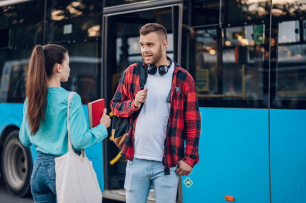 istock Two friends waiting for a public transport at a bus stop 1412305435