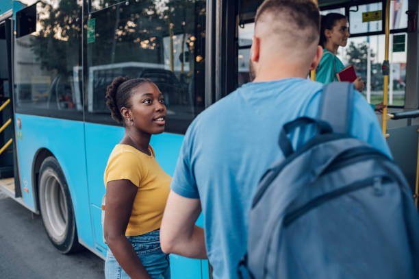 istock Multiracial friends waiting for a bus while at a bus stop 1412305437