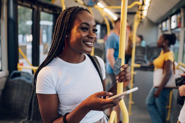 istock African american woman using smartphone while riding a bus in the night 1412305446