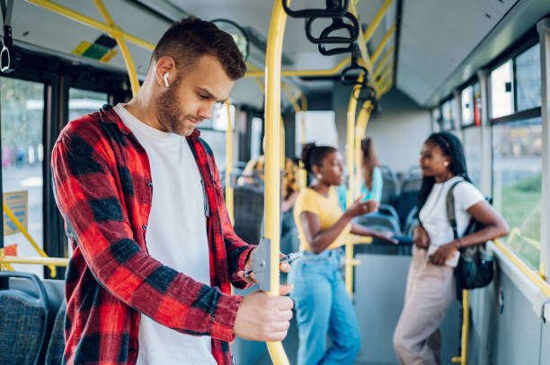 istock Man is riding in a bus and using a smartphone and airpods 1412305450