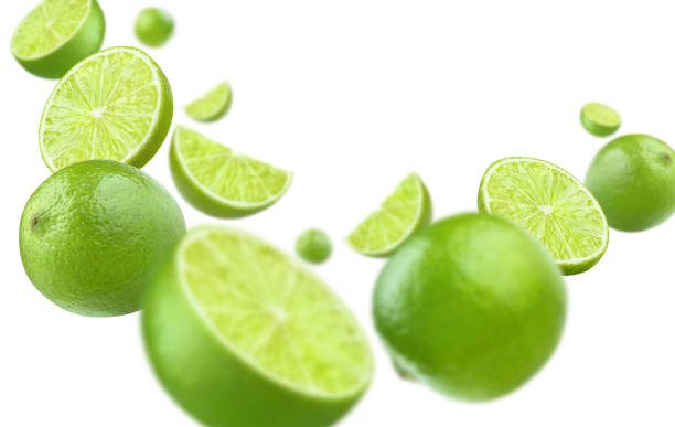 istock Flying lime fruits on white 1412306811