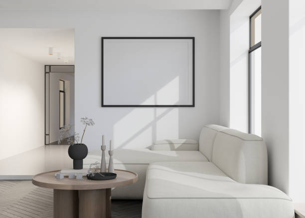 istock Empty black horizontal picture frame on white wall in modern living room. Mock up interior in contemporary style. Free, copy space for your picture, poster. Sofa, table with vase. 3D rendering. 1412307845