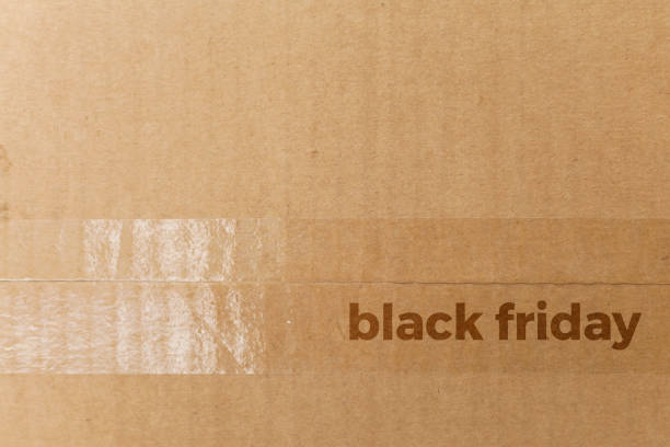 Detail of a cardboard box written on black friday Detail of a cardboard box written on black friday. Delivery box. cardboard box concept. black friday concept merchants gate stock pictures, royalty-free photos & images