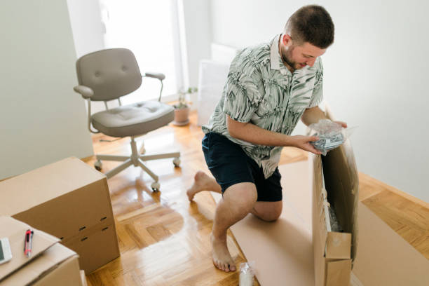 istock Male customer unpacking delivery box,  online shopping shipment 1412309825