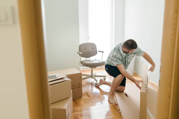 istock Male customer unpacking delivery box,  online shopping shipment 1412312027