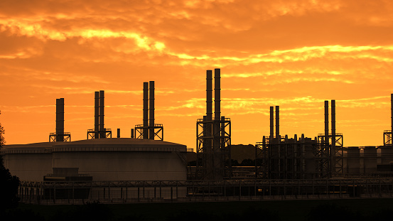 Oil and gas refinery during sunset.