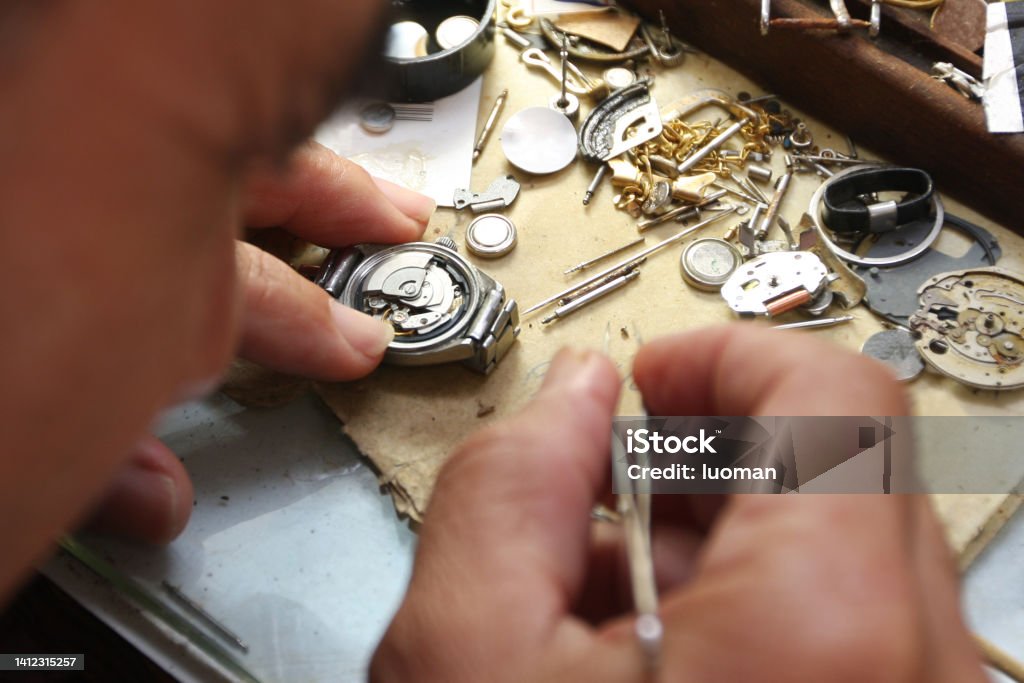 watchmaker working Watchmaker holding tweezers Clock Stock Photo