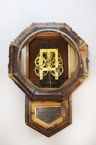 Sepia toned image of an old clock face isolated on a white background