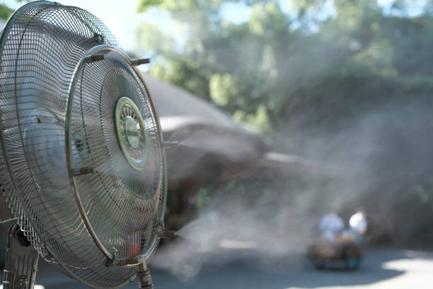 istock Outdoor misting fan spreading mist 1412317643