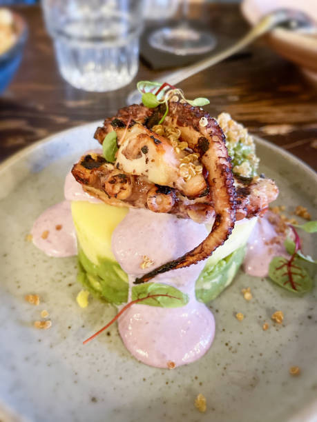 istock Grilled octopus with polenta and yogurt at a restaurant 1412318076