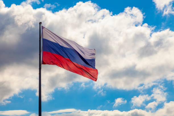 istock The flag of Russia develops in the wind against a cloudy sky 1412322221