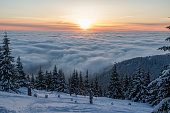 Inversion weather in winter mountains during dawn