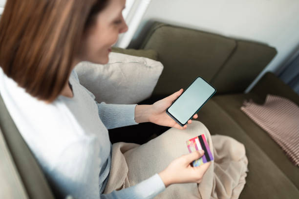 istock Young woman using her smartphone for online shopping 1412328795