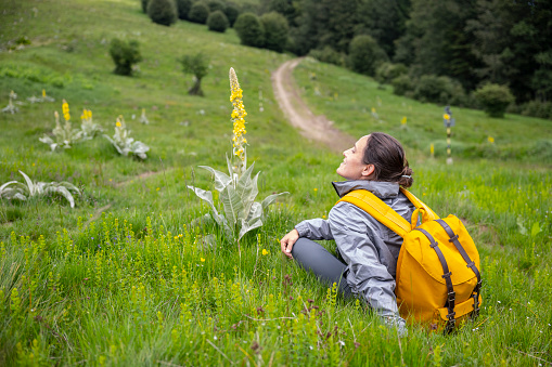 Weekend Activities. Tourism in Nature, woman hiking in the highlands on a day trip.