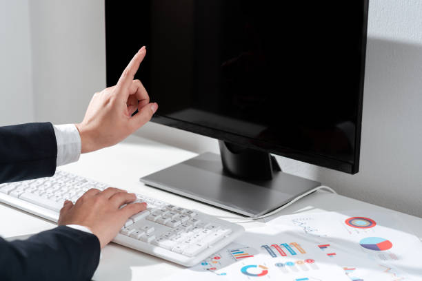 istock Businesswoman Typing Recent Updates On Lap Top Keyboard On Desk And Pointing Important Ideas With One Finger. Woman In Office Writing Late Messages On Computer. 1412329366