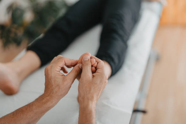 istock masseur's hands doing reflexology on a woman's feet 1412329562