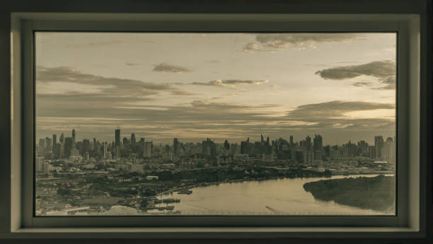 istock Skyscrapers along Chao phraya river in the evening time. Seen through a bedroom window frame. The beautiful view of Bangkok city, 1412329905