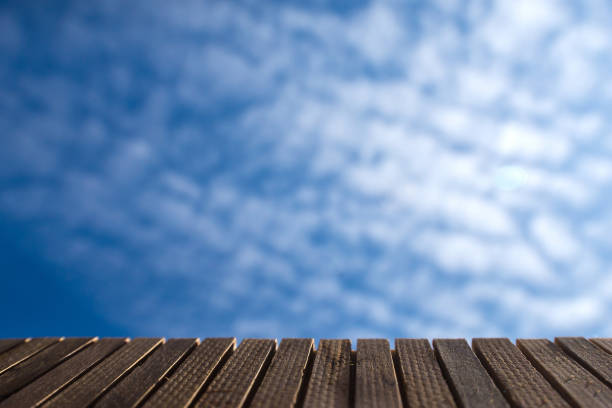 Empty wooden deck Against the backdrop of clear sky and bright clouds.