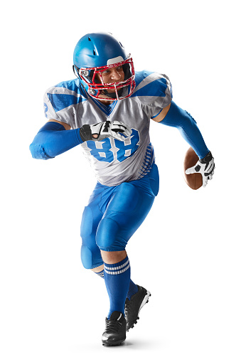 Sports attack. Sportsman in action. American football. A young agile American football player runs fast. Sport
