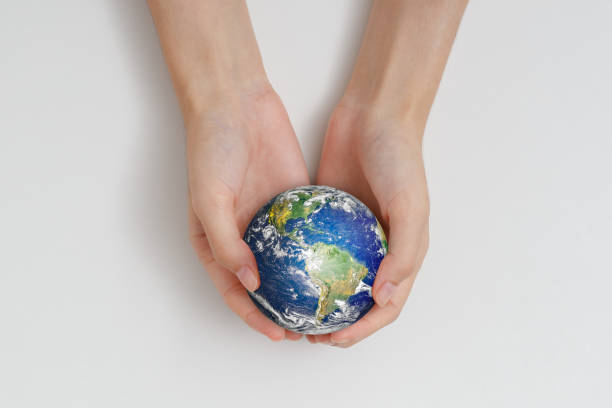 istock Human hand holding earth. Protect the environment to save the world concept. Elements of this image furnished by NASA. 1412337970