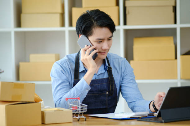 istock Asian business owner always keep contact with customer. 1412338239
