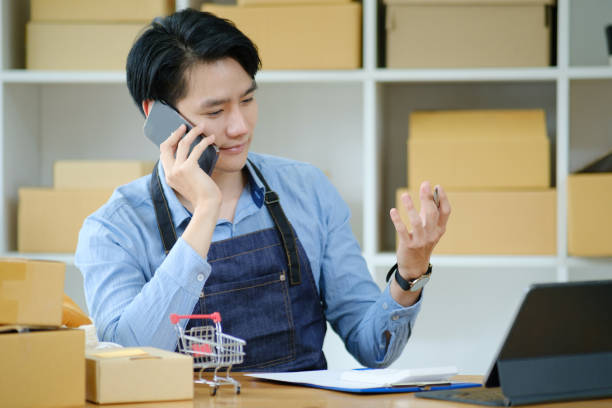 istock Asian business owner always keep contact with customer. 1412338250