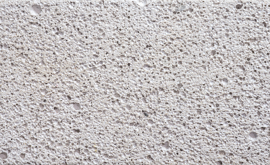 Detalles superficie porosidad pared de hormigón blanco. photo