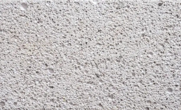 Photo of Details surface porosity white concrete wall.