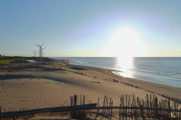 Beautiful sand dune and windmill at the beach in Dayuan District, Taoyuan, Taiwan
