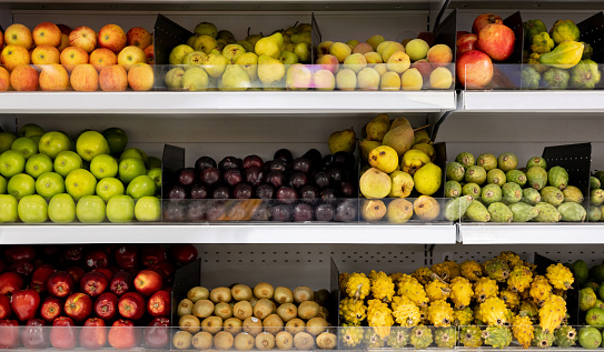 Fresh fruits on the shelves at a supermarket - grocery shopping concepts