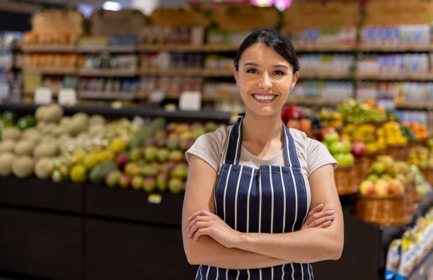 istock Happy woman working at a supermarket 1412353032