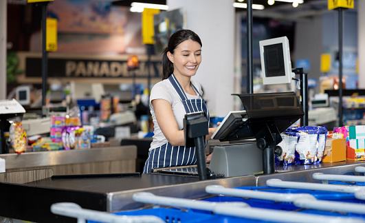 Happy Cashier Working At The Supermarket Stock Photo Download Image Happy Cashier Working At The Supermarket Stock Photo Download Image