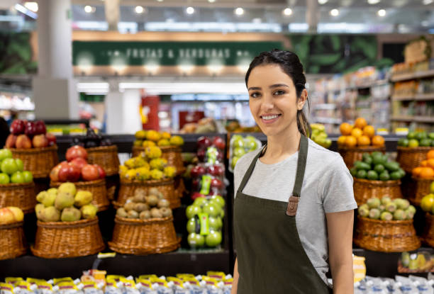 istock Happy woman working at a supermarket 1412353077
