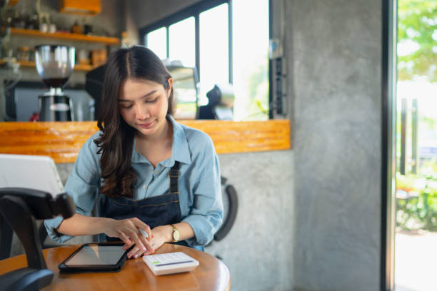 istock Coffee business owners use tablets to scan to receive payments from customers. 1412353602