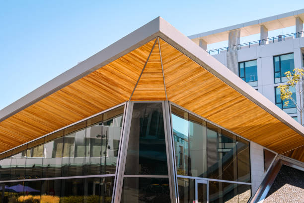 The interplay between textured brown panels and sleek reflective glass creates a dynamic contrast, highlighting contemporary design elements.