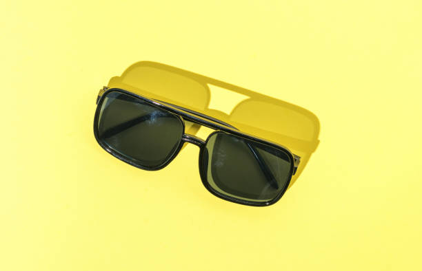istock Sunglasses in bright light on a yellow background. 1412354316
