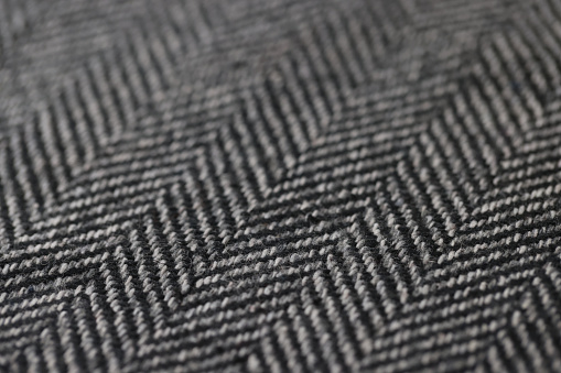 Closeup of black and white herringbone fabric. Texture fabric background concept