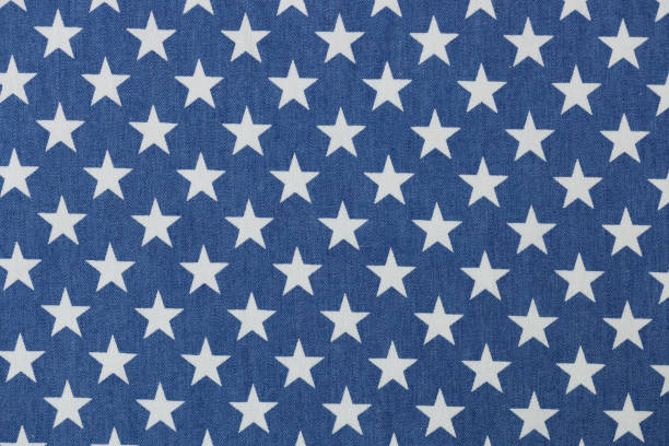 Blue fabric with white stars texture background. Stars seamless pattern concept