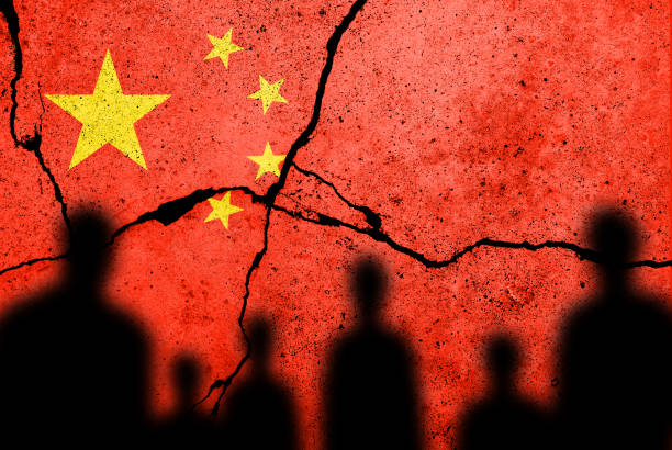 Flag of China painted on a cracked wall. Chinese real estate and debt crisis stock photo