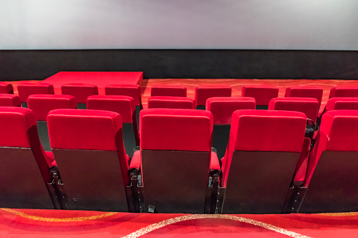 Close up of empty red cinema or theater armchair. Mock up, 3D Rendering