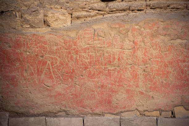 Vandalized wall of the temple of the sun in Pachacamac. Some bad visitors make inscriptions on the walls of the temple stock photo