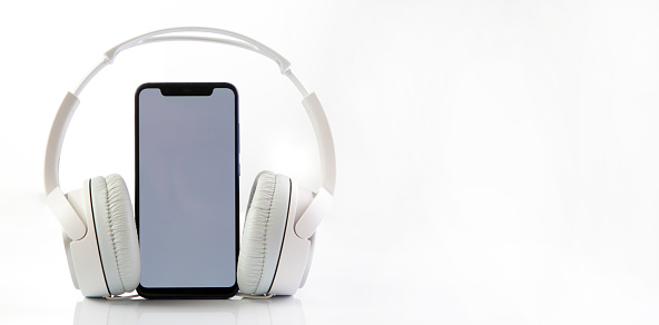 White headphones on smartphone music online concept, mockup, isolate on white