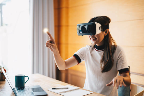 istock young asian woman touching the air during the VR experience 1412370619