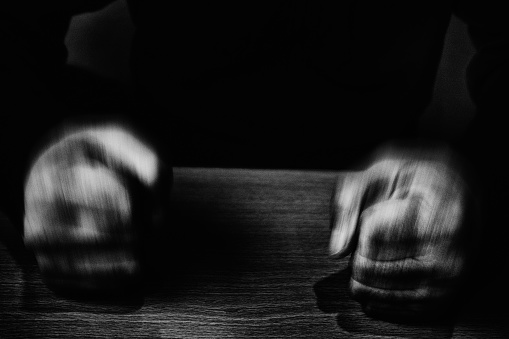 Image of a man's fist hitting the table