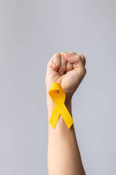 istock Suicide prevention day, Childhood, Sarcoma, bone and bladder cancer Awareness month, Yellow Ribbon for supporting people life and illness. children Healthcare and World cancer day concept 1412373554