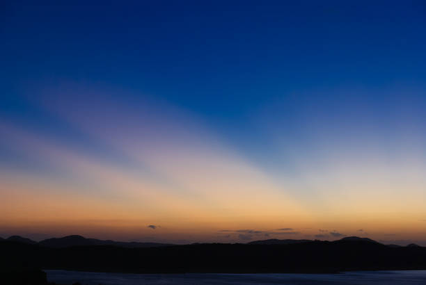 istock Sunset over a lake in a tropical landscape 1412373876