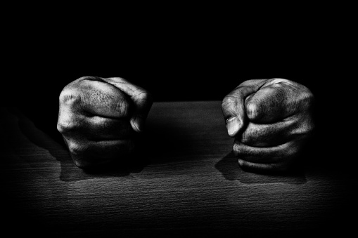 Image of a man's fist hitting the table