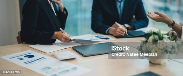 Asian Business Adviser Meeting To Analyze And Discuss The Situation On The Financial Report In The Meeting Roominvestment Consultantfinancial Consultantfinancial Advisor And Accounting Concept Stock Photo - Download Image Now