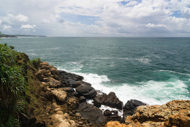 istock Rocky tropical coastline with stormy sky 1412375212