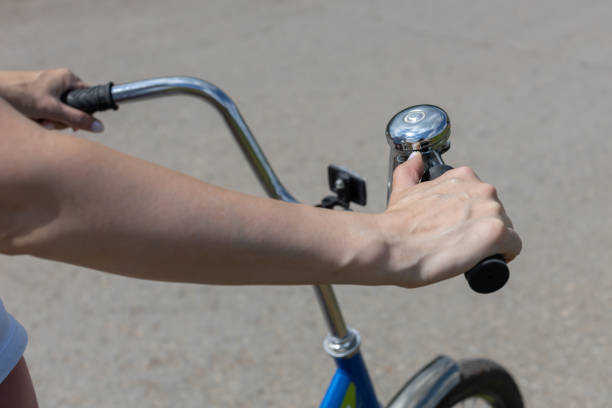 istock woman pulling the trigger of a bicycle bell 1412381421